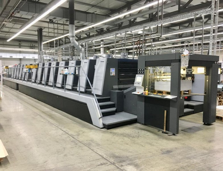 Ink rollers running on a commercial offset printing press